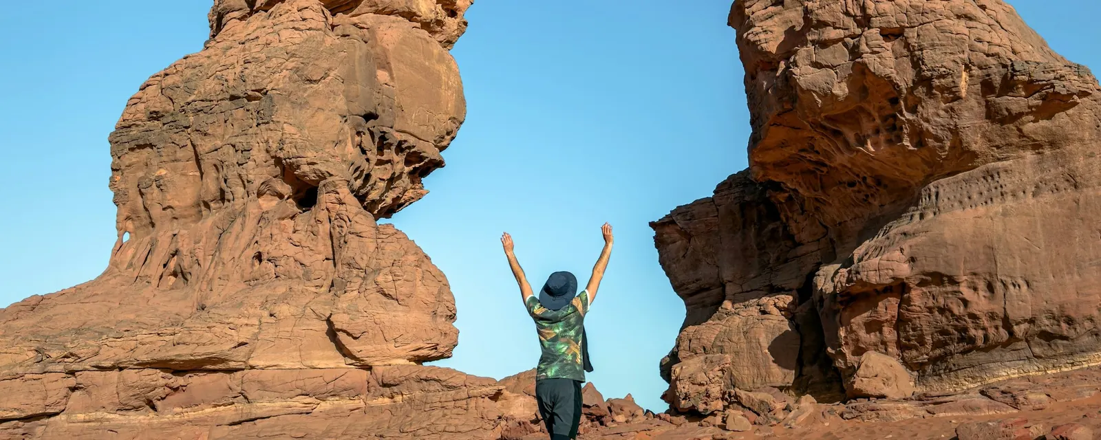 A traveler between sandstone towers near Djanet in the Sahara